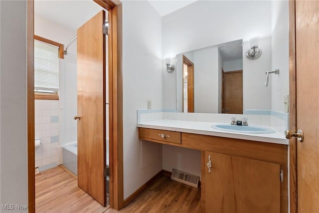 4130 Atwood Ave SE, Canton, OH 44707 - full bath featuring wood finished floors, vanity, and shower / bathtub combination