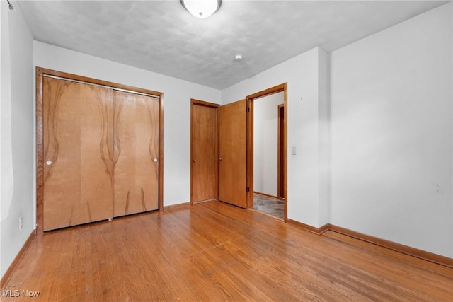4130 Atwood Ave SE, Canton, OH 44707 - unfurnished bedroom featuring wood finished floors and a closet
