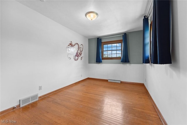 4130 Atwood Ave SE, Canton, OH 44707 - spare room featuring wood finished floors and a wainscoted wall