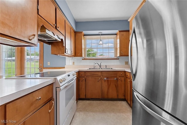 4130 Atwood Ave SE, Canton, OH 44707 - kitchen with freestanding refrigerator, electric range, under cabinet range hood, and brown cabinetry