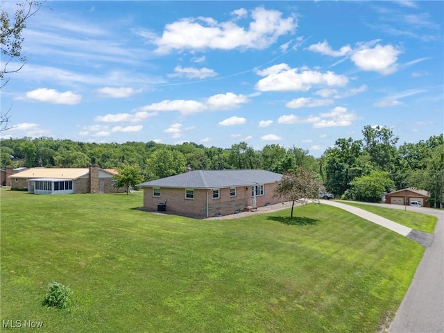 4130 Atwood Ave SE, Canton, OH 44707 - view of front of house with a detached garage, a front lawn, and brick siding