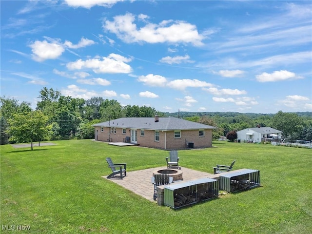 4130 Atwood Ave SE, Canton, OH 44707 - back of house featuring an outdoor fire pit, a yard, a patio, and brick siding