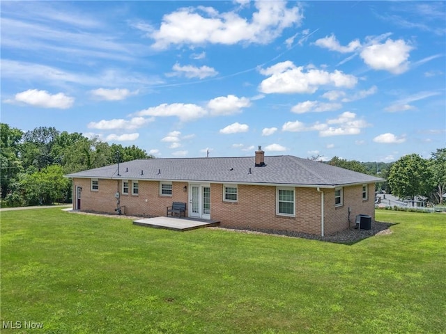 4130 Atwood Ave SE, Canton, OH 44707 - back of house with french doors, a lawn, a patio area, and brick siding