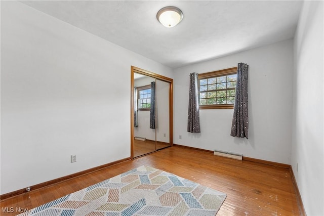 4130 Atwood Ave SE, Canton, OH 44707 - unfurnished room featuring wood-type flooring and a baseboard radiator