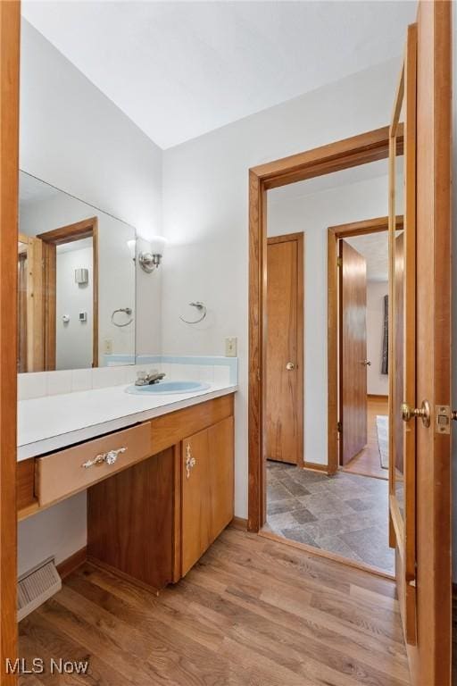 4130 Atwood Ave SE, Canton, OH 44707 - bathroom featuring vanity and wood finished floors