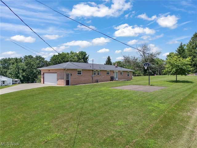 4130 Atwood Ave SE, Canton, OH 44707 - rear view of house featuring driveway, an attached garage, a lawn, and brick siding