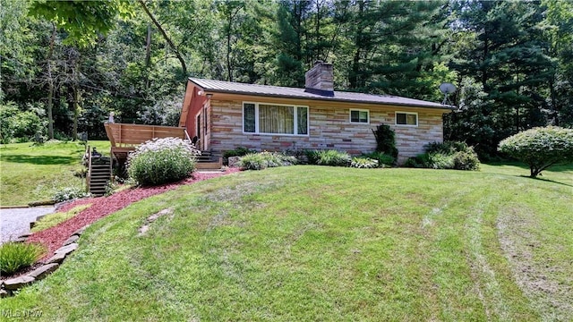 5882 Crooked Run Rd SW, New Philadelphia, OH 44663 - view of front facade with a chimney, stone siding, a front yard, a wooden deck, and a metal roof