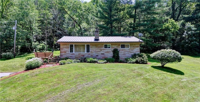 5882 Crooked Run Rd SW, New Philadelphia, OH 44663 - view of front of home with a chimney, a front lawn, a view of trees, and a metal roof