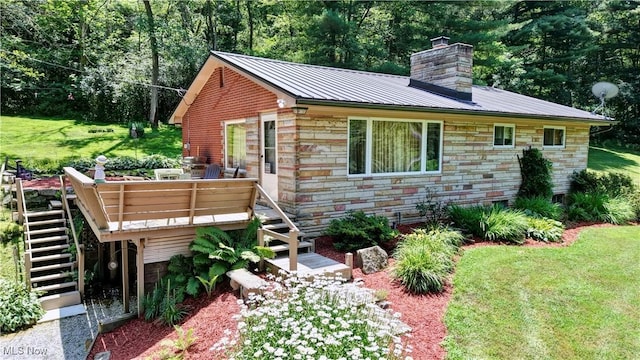 5882 Crooked Run Rd SW, New Philadelphia, OH 44663 - view of front facade with stairs, stone siding, a deck, a metal roof, and a chimney