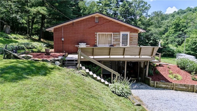 5882 Crooked Run Rd SW, New Philadelphia, OH 44663 - back of house with a wooden deck, stairway, a yard, brick siding, and a wooded view