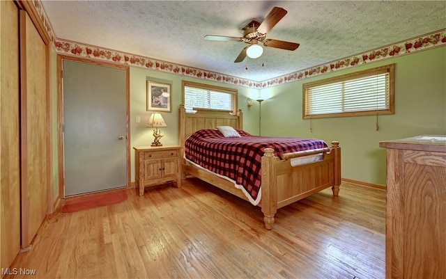 5882 Crooked Run Rd SW, New Philadelphia, OH 44663 - bedroom with a textured ceiling, light wood finished floors, and ceiling fan
