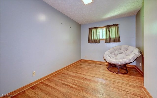 5882 Crooked Run Rd SW, New Philadelphia, OH 44663 - sitting room with light wood finished floors and a textured ceiling