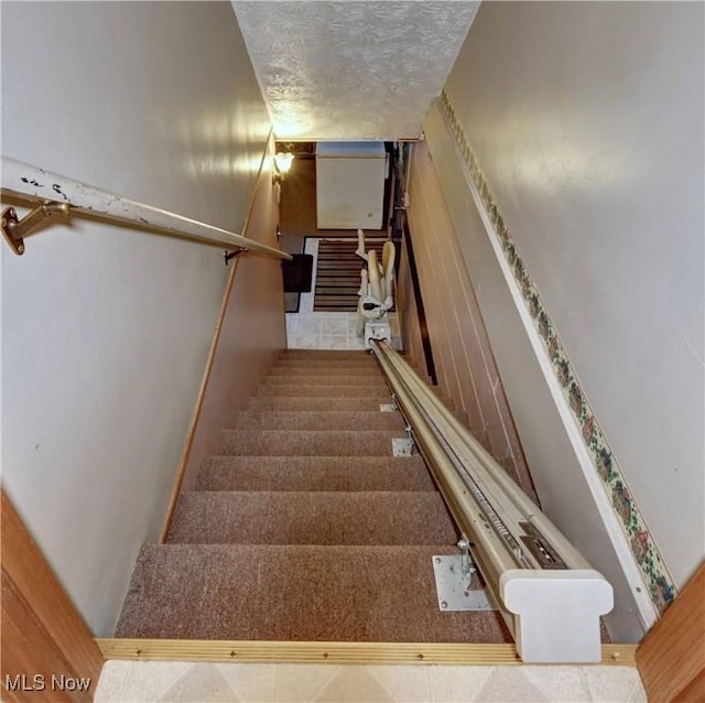 5882 Crooked Run Rd SW, New Philadelphia, OH 44663 - stairway with a textured ceiling