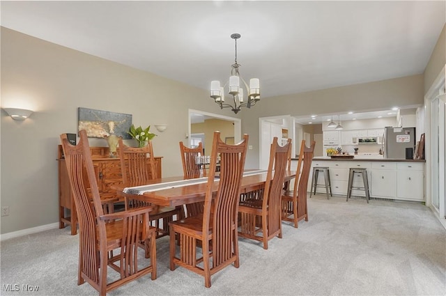 889 Eaton Ave, Akron, OH 44303 - dining space featuring light carpet and a chandelier
