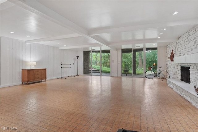 889 Eaton Ave, Akron, OH 44303 - unfurnished living room with a stone fireplace and beamed ceiling