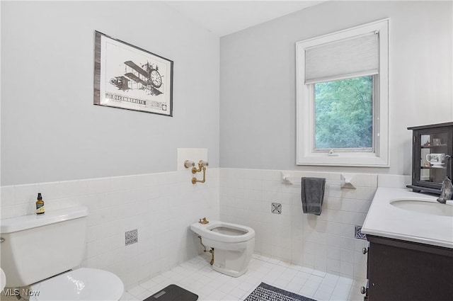 889 Eaton Ave, Akron, OH 44303 - bathroom featuring tile walls, vanity, tile patterned floors, wainscoting, and a bidet