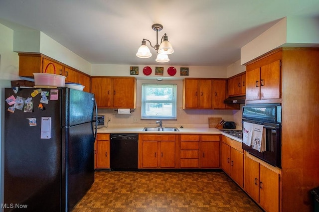 3800 7th Ave, Vienna, WV 26105 - kitchen featuring black appliances, light countertops, brown cabinetry, and a chandelier