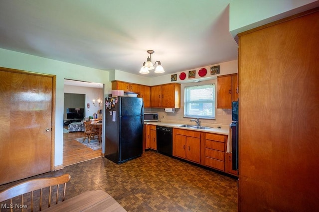 3800 7th Ave, Vienna, WV 26105 - kitchen with black appliances, light countertops, a chandelier, brown cabinets, and pendant lighting