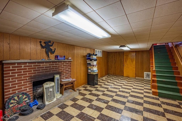 3800 7th Ave, Vienna, WV 26105 - finished below grade area with light floors, wood walls, stairway, and a brick fireplace