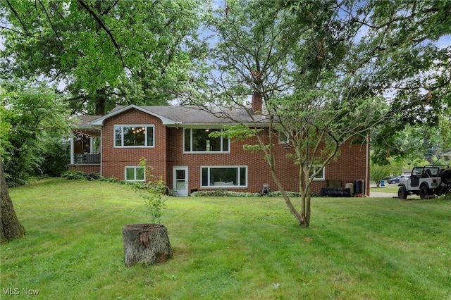 903 Robinson Ave, Barberton, OH 44203 - view of front of property featuring a front yard, brick siding, and a chimney