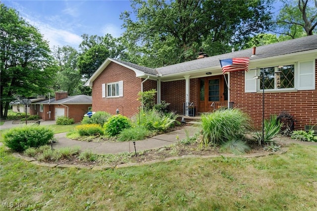 903 Robinson Ave, Barberton, OH 44203 - single story home featuring brick siding, a garage, a chimney, and a front yard