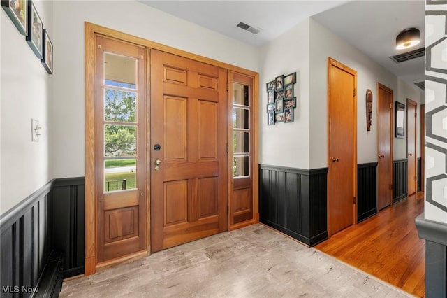 903 Robinson Ave, Barberton, OH 44203 - entryway with light wood finished floors and a wainscoted wall