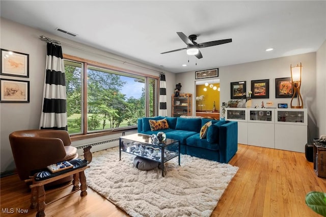 903 Robinson Ave, Barberton, OH 44203 - living area featuring baseboard heating, a ceiling fan, wood finished floors, and recessed lighting