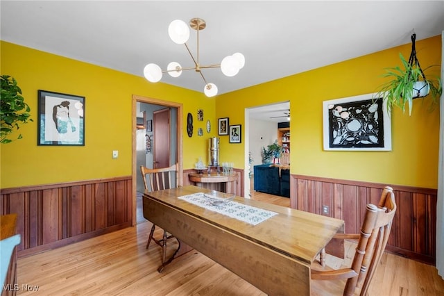 903 Robinson Ave, Barberton, OH 44203 - dining room featuring a wainscoted wall, wood finished floors, a chandelier, and wood walls
