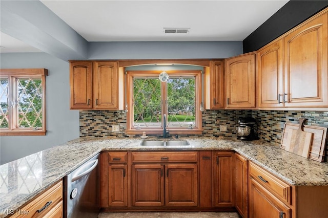 903 Robinson Ave, Barberton, OH 44203 - kitchen with dishwasher, light stone countertops, backsplash, and brown cabinetry