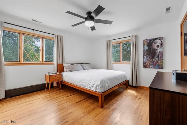 903 Robinson Ave, Barberton, OH 44203 - bedroom with multiple windows, light wood finished floors, and a ceiling fan