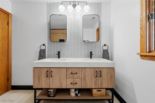 903 Robinson Ave, Barberton, OH 44203 - full bathroom with double vanity and wood finished floors