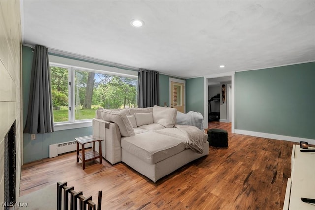903 Robinson Ave, Barberton, OH 44203 - living area featuring a baseboard radiator, wood finished floors, recessed lighting, and a fireplace