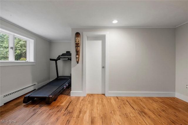 903 Robinson Ave, Barberton, OH 44203 - workout room featuring baseboard heating, light wood-style flooring, and crown molding