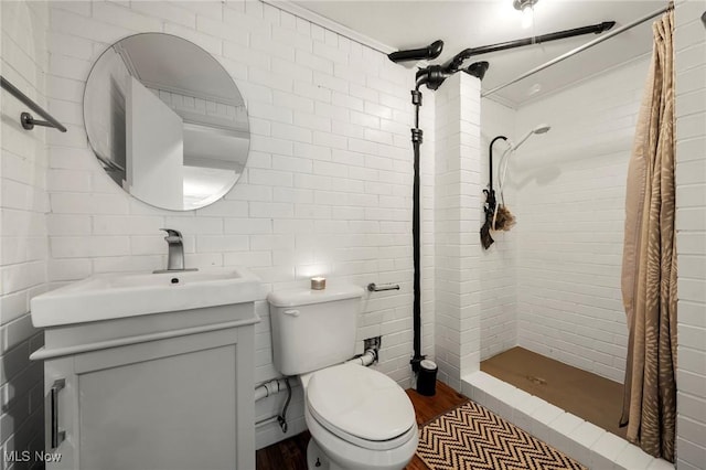 903 Robinson Ave, Barberton, OH 44203 - full bath with wood finished floors, a tile shower, vanity, and tile walls