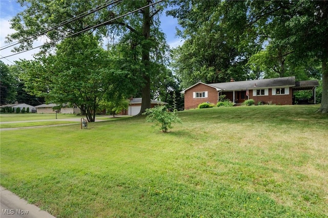903 Robinson Ave, Barberton, OH 44203 - view of front of home featuring brick siding, a front lawn, and a chimney