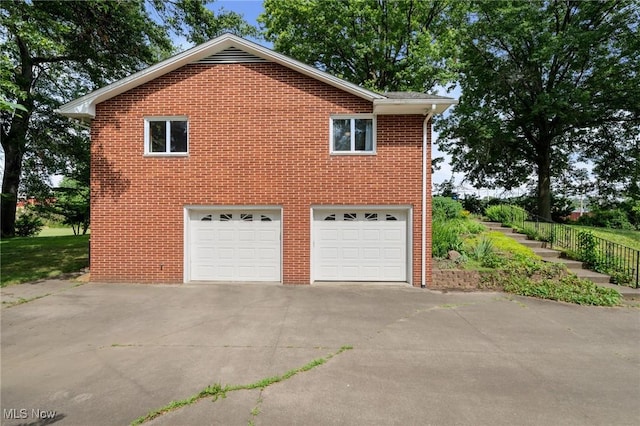903 Robinson Ave, Barberton, OH 44203 - view of property exterior featuring driveway, brick siding, and a garage
