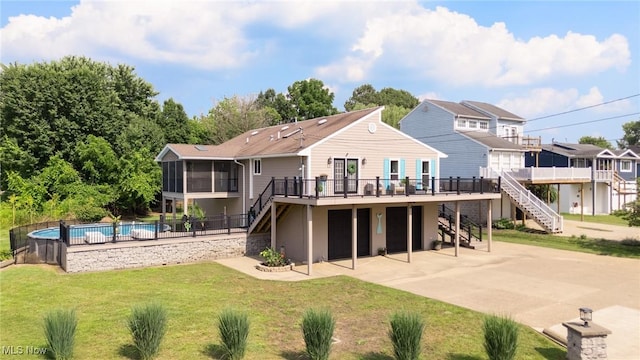 31 Anns Dr, Vienna, WV 26105 - rear view of house with stairway, a sunroom, a deck, and concrete driveway