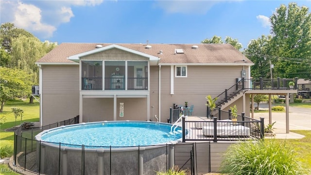 31 Anns Dr, Vienna, WV 26105 - view of swimming pool featuring stairs, a deck, and a sunroom
