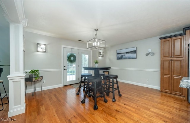 31 Anns Dr, Vienna, WV 26105 - dining area with ornate columns, light wood-type flooring, and a chandelier