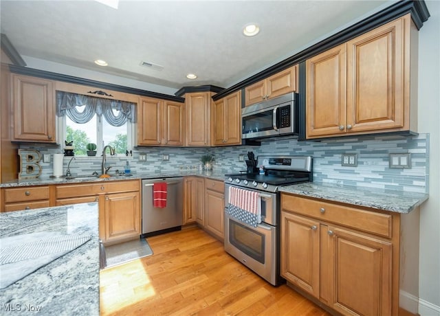 31 Anns Dr, Vienna, WV 26105 - kitchen featuring stainless steel appliances, light stone countertops, light wood-type flooring, backsplash, and recessed lighting