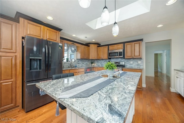 31 Anns Dr, Vienna, WV 26105 - kitchen featuring stainless steel appliances, a skylight, backsplash, light stone counters, and recessed lighting