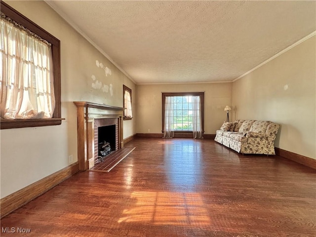 825 Summit St, Salem, OH 44460 - unfurnished living room with wood finished floors, a textured ceiling, a brick fireplace, and ornamental molding