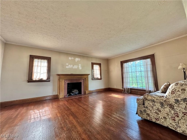 825 Summit St, Salem, OH 44460 - unfurnished living room with wood-type flooring, plenty of natural light, a fireplace, a textured ceiling, and crown molding