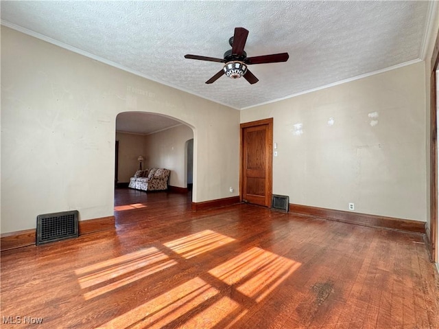 825 Summit St, Salem, OH 44460 - unfurnished room featuring wood finished floors, arched walkways, a ceiling fan, a textured ceiling, and ornamental molding