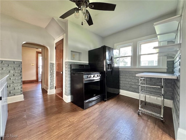 825 Summit St, Salem, OH 44460 - kitchen with gas range, black refrigerator with ice dispenser, arched walkways, ceiling fan, and wood finished floors