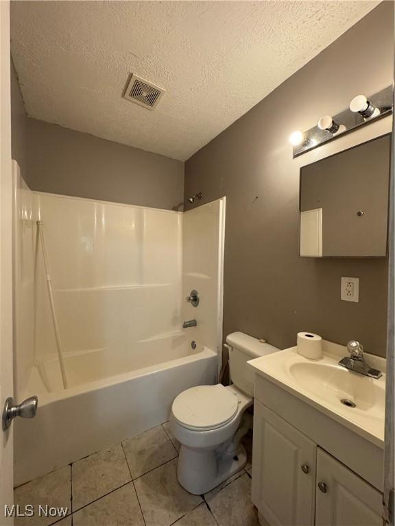 67 Neil Ann Dr, Parkersburg, WV 26101 - bathroom with a textured ceiling, vanity,  shower combination, and tile patterned floors