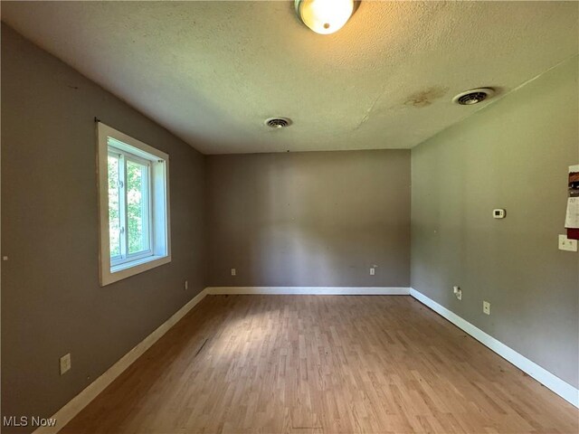 67 Neil Ann Dr, Parkersburg, WV 26101 - empty room with a textured ceiling and wood finished floors