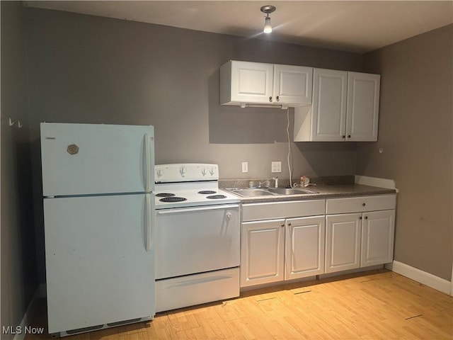 67 Neil Ann Dr, Parkersburg, WV 26101 - kitchen featuring white appliances, light wood-style floors, and white cabinetry
