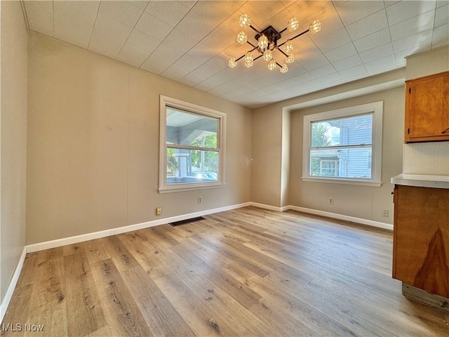 329 E Broad St, Newton Falls, OH 44444 - unfurnished dining area featuring light wood finished floors and a chandelier
