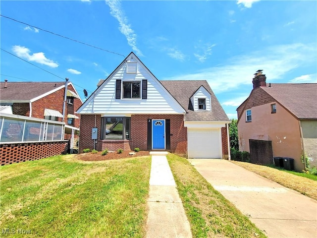 1006 Jackson Ave, Parkersburg, WV 26101 - view of front of house featuring brick siding, a garage, driveway, and a front lawn